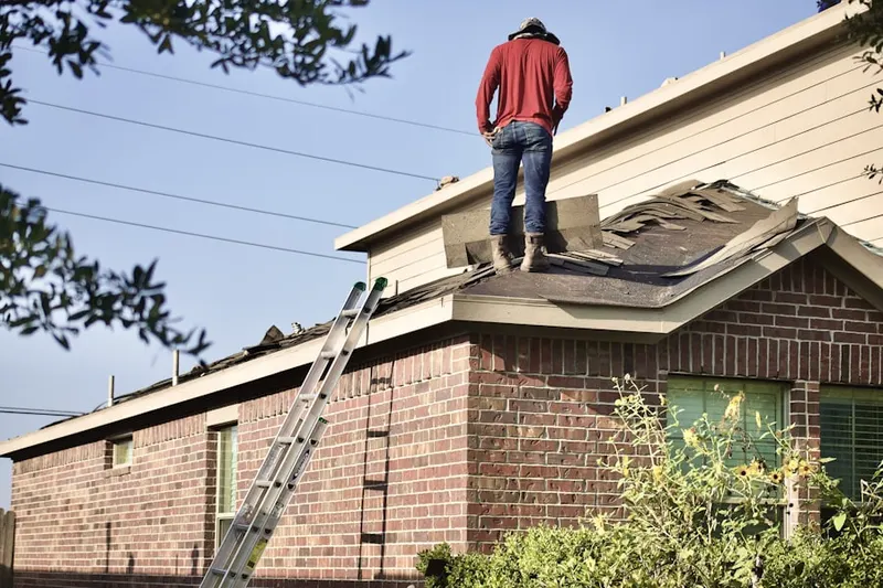 Professional roofer working on a residential roof in Northpark
